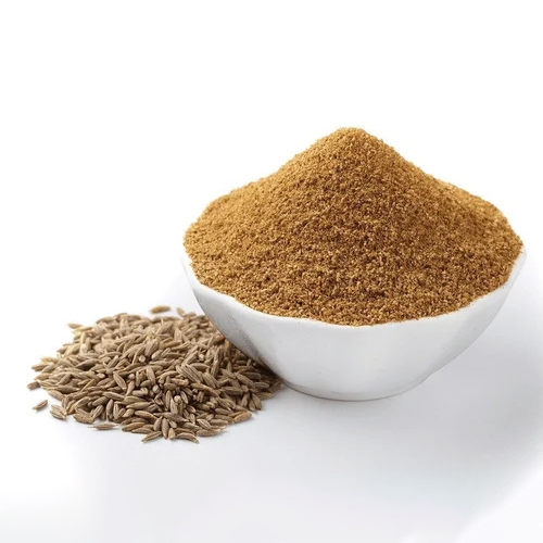 a bowl of brown powder next to a pile of seeds